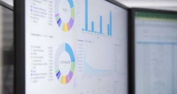 A computer monitor showing data, charts, and pie graphs.