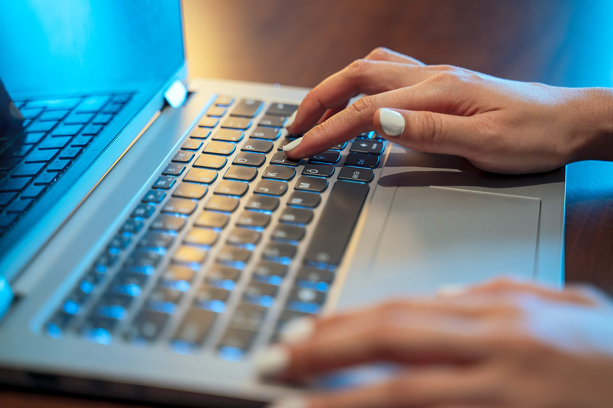 Close up of hands typing on laptop